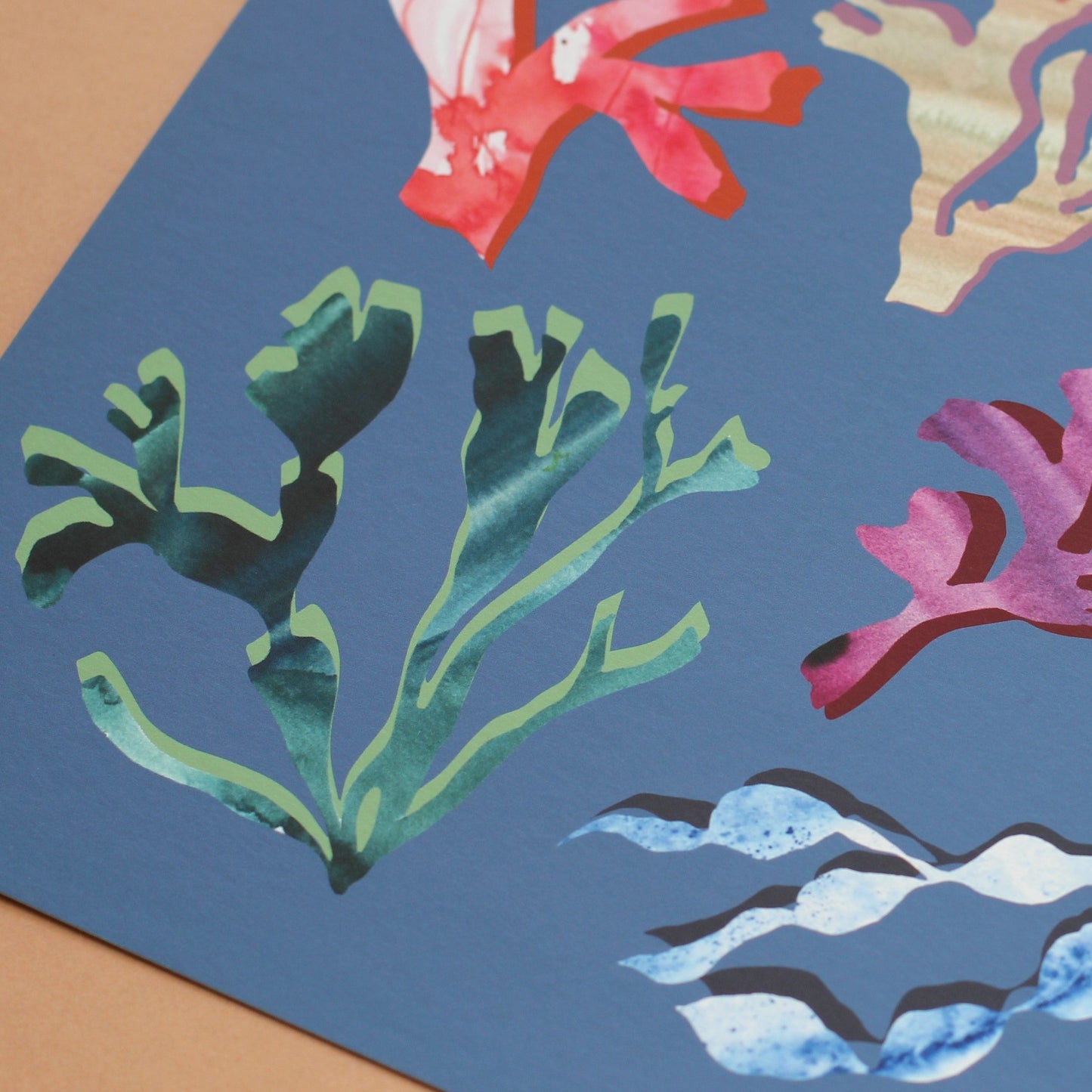 detail shot of a coastal art print of corals and seaweeds in bright colours. 